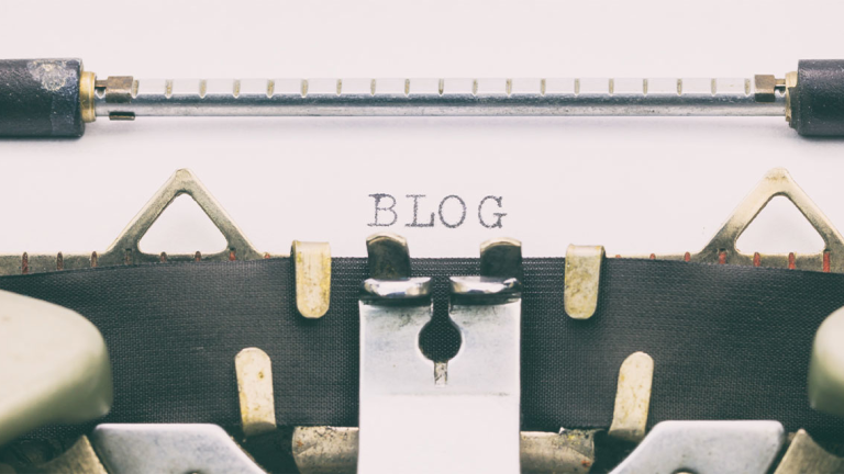 A typewriter with the word Blog typed on the paper.